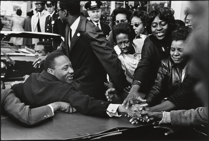 Martin Luther King greets onlookers from a motorcade in Baltimore, 1966. [Photo courtesy of Swann Auction Galleries]
